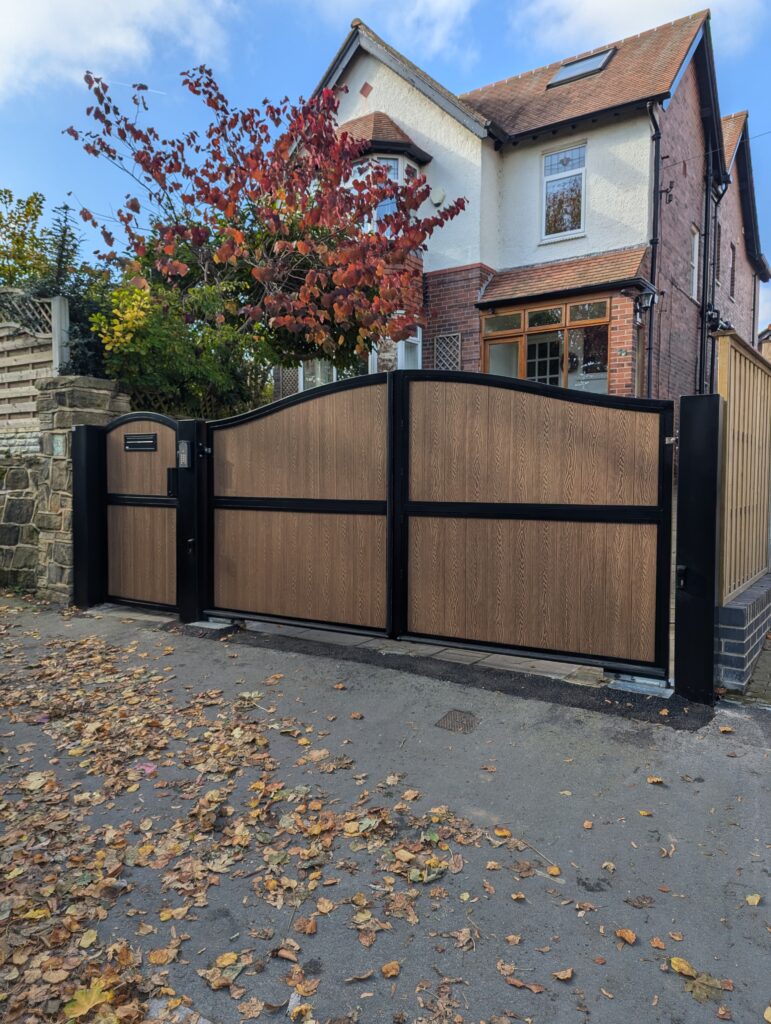 Black frame composite driveway gates installed at residential property